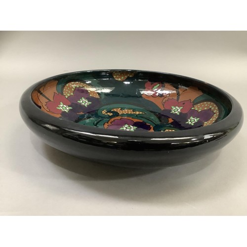 38 - A twentieth century Art Deco glass bowl, the interior painted with purple flowers with foliage on an... 