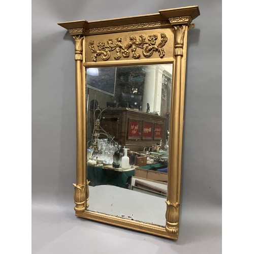 441 - A gilt mirror of early 19th century style having applied foliate scroll and inverted break front ped... 