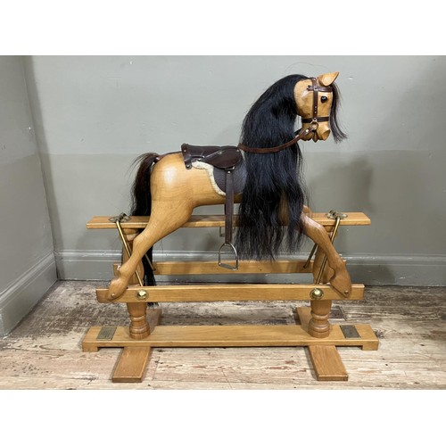 449 - A child's beech rocking horse by White Horse Company on turned pillars and cross platform stretchers... 