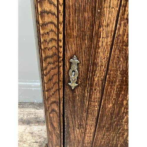 460 - A 19th century oak corner hanging cupboard having  moulded cornice above semi arched panel door and ... 