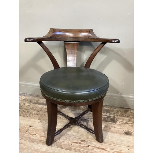 461 - A Victorian walnut tub back chair with green leather upholstered revolving seat