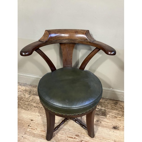 461 - A Victorian walnut tub back chair with green leather upholstered revolving seat