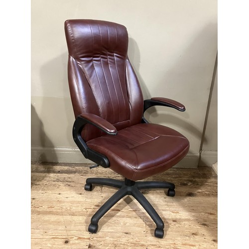 467 - A swivel office chair in burgundy leather effect upholstery