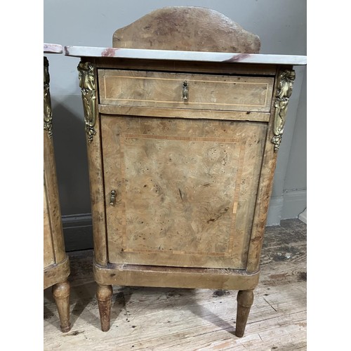 472 - A pair of late 19th century figured walnut and gilt metal mounted bedside cabinets with marble tops ... 