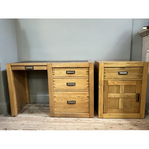 479 - An elm desk having an incised writing surface with narrow drawer to the kneehole flanked by two draw... 