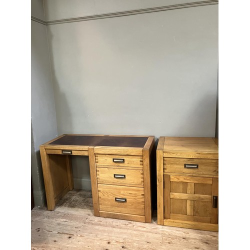 479 - An elm desk having an incised writing surface with narrow drawer to the kneehole flanked by two draw... 