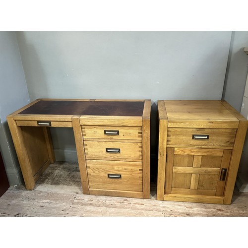 479 - An elm desk having an incised writing surface with narrow drawer to the kneehole flanked by two draw... 