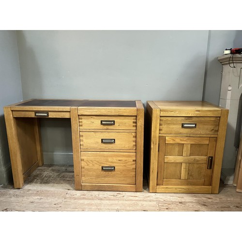 479 - An elm desk having an incised writing surface with narrow drawer to the kneehole flanked by two draw... 