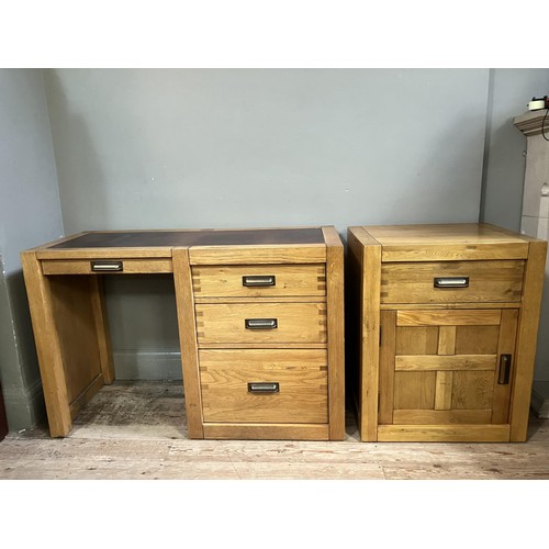 479 - An elm desk having an incised writing surface with narrow drawer to the kneehole flanked by two draw... 