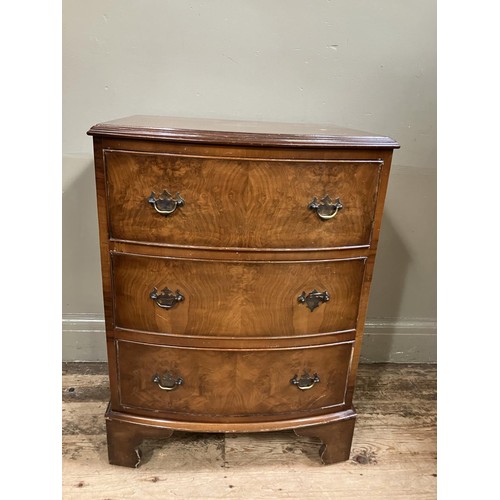 482 - A walnut veneered bow fronted chest of three graduated drawers on shaped bracket feet, 56cm wide x 7... 