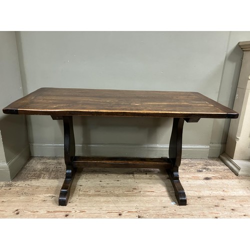 492 - An oak refectory dining table on shaped standards and platform stretcher, 150cm x 74cm