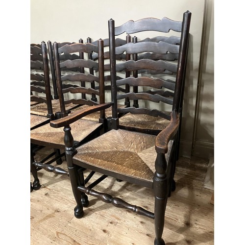 493 - A set of eight early 20th century ladder back and rush seated dining chairs comprising two carvers a... 