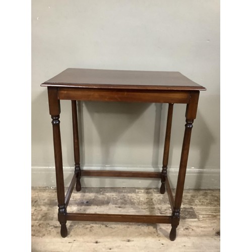 500 - A mahogany occasional table of rectangular outline on slender turned legs joined by peripheral stret... 