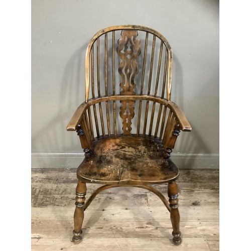 505 - A 19th century high back Windsor with pierced splat and rails, turned uprights and legs joined by a ... 