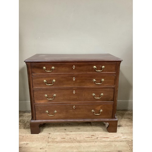 508 - A mahogany and cross banded chest of four graduated drawers with brass swing handles and on shaped b... 