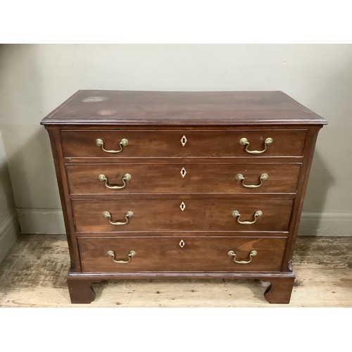 508 - A mahogany and cross banded chest of four graduated drawers with brass swing handles and on shaped b... 