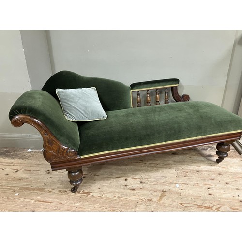 510 - A Victorian walnut chaise longue upholstered in green velvet and on turned legs