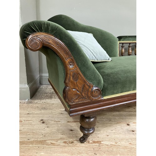 510 - A Victorian walnut chaise longue upholstered in green velvet and on turned legs