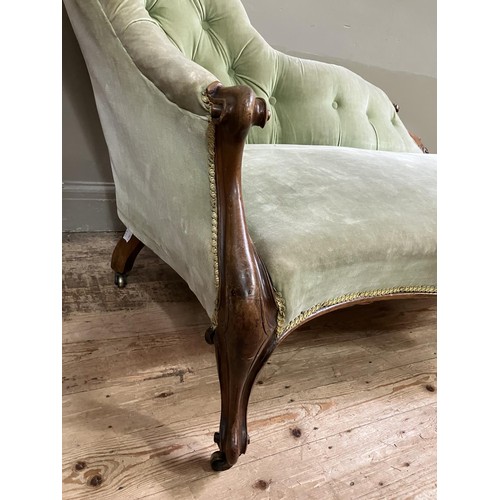 511 - A Victorian walnut chaise long upholstered in a pale green velvet (back at fault)