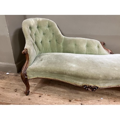 511 - A Victorian walnut chaise long upholstered in a pale green velvet (back at fault)