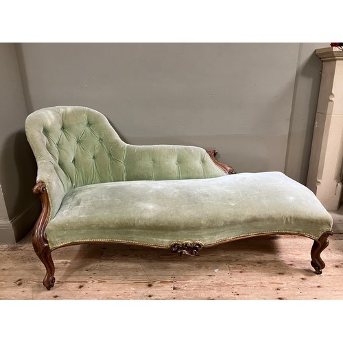 511 - A Victorian walnut chaise long upholstered in a pale green velvet (back at fault)