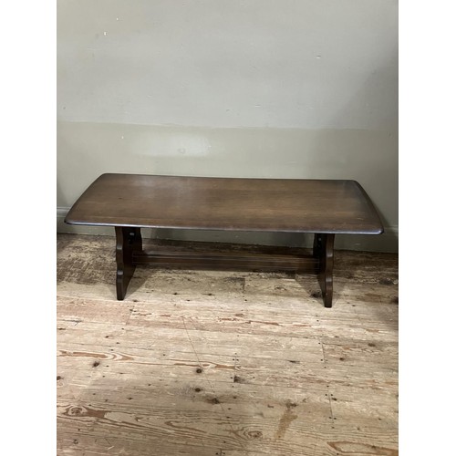 512 - An oak reproduction coffee table on trestle supports