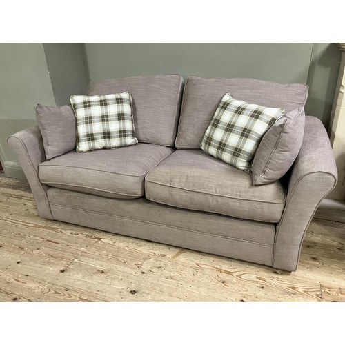 515 - A two seater sofa upholstered in mushroom linen with loose cushions