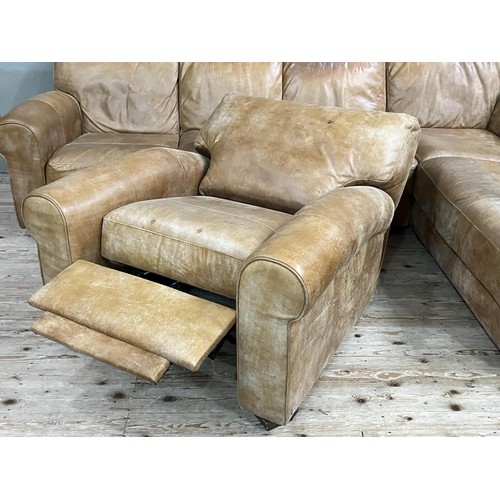 516 - An 'L' shaped corner sofa in tan leather with matching reclining armchair, purchased from Barker and... 