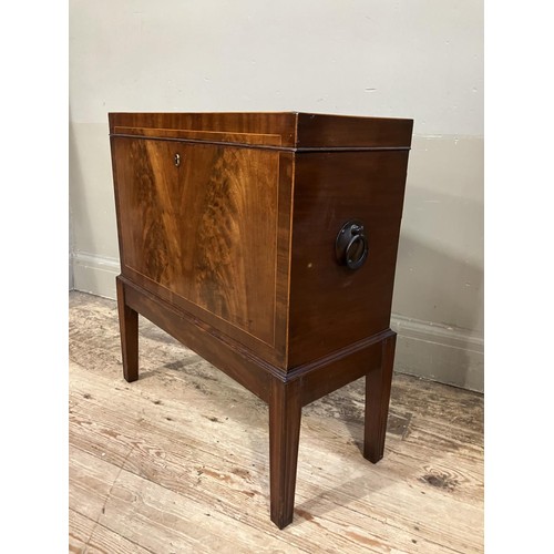 517 - An early 20th century figured mahogany cellarette, rectangular and having a lift up top, fitted for ... 