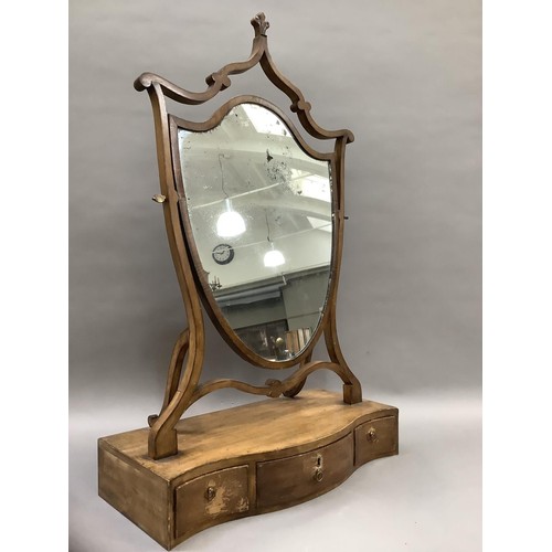 518 - An Edwardian shield shaped toilet mirror on a serpentine base fitted with three drawers, 53cm wide, ... 