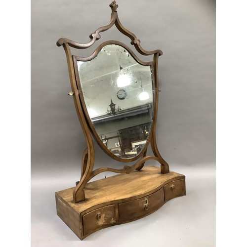 518 - An Edwardian shield shaped toilet mirror on a serpentine base fitted with three drawers, 53cm wide, ... 