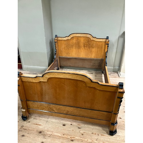 427 - A 19th century continental birdseye maple and ebonised bedstead of double size having a semi arched ... 