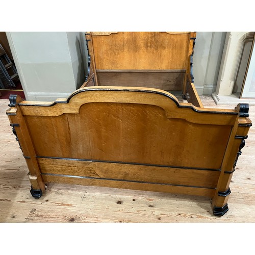 427 - A 19th century continental birdseye maple and ebonised bedstead of double size having a semi arched ... 