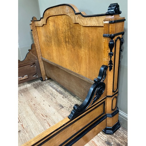 427 - A 19th century continental birdseye maple and ebonised bedstead of double size having a semi arched ... 