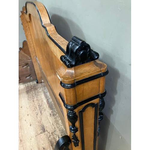 427 - A 19th century continental birdseye maple and ebonised bedstead of double size having a semi arched ... 