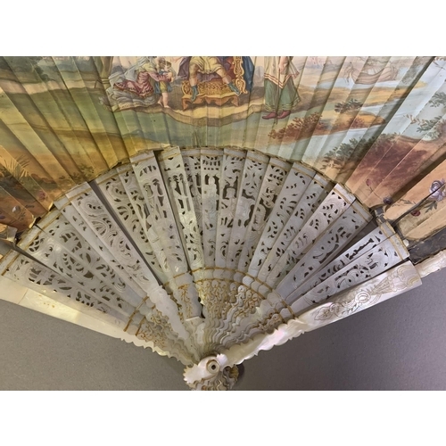 3 - An 18th century mother of pearl fan with leaf of painted silk, showing a man seated on a throne, a m... 