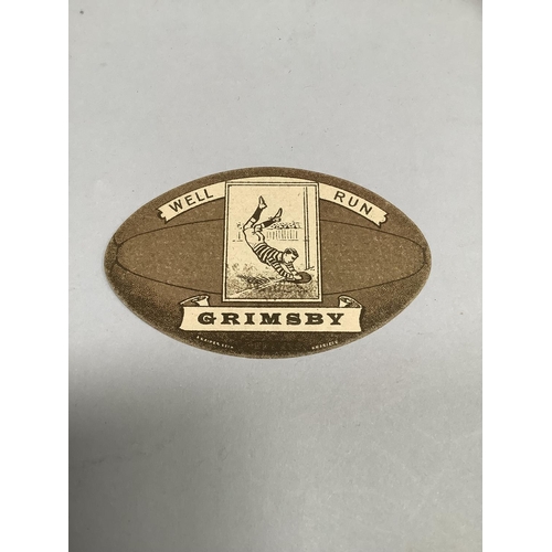 59 - A. Bains Rugby card for Grimsby, shaped and printed as a rugby ball. 6cm x 9.5cm.