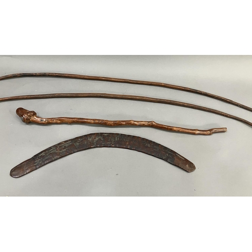 33 - A 19th century Aboriginal boomerang and two bows, together with a Chinese root wood stick