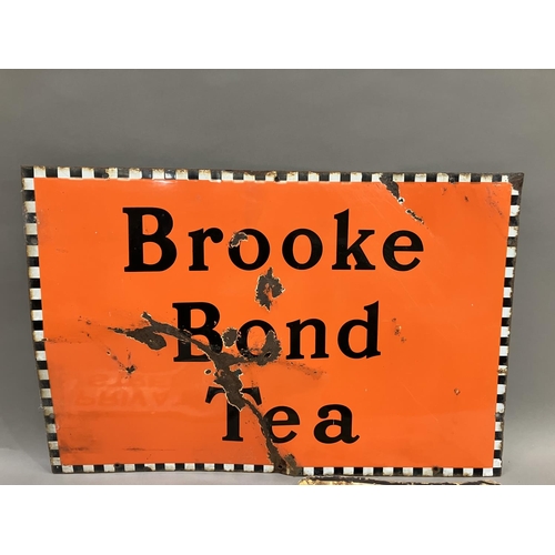 61B - A Brooke Bond Tea enamel sign in orange, black and white, 76cm x 51cm together with a white enamel a... 