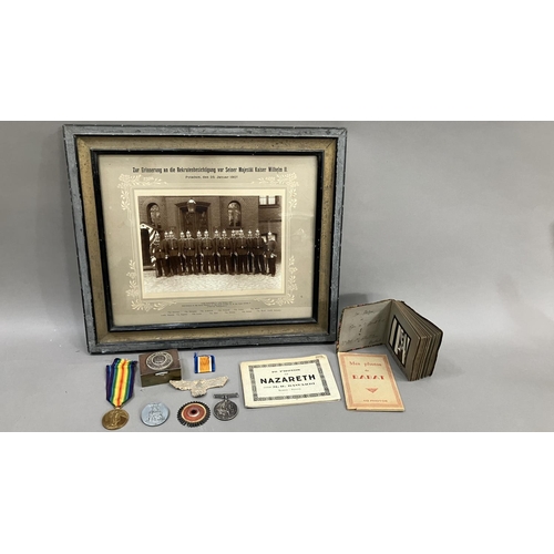 7 - Early 20th century German militaria including an album of black and white photographic cigarette car... 