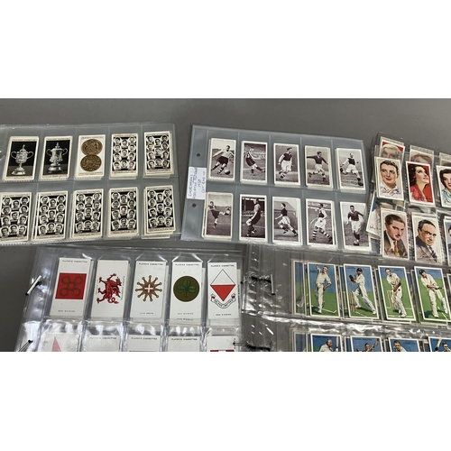 161 - Forty cigarette card sets and part sets, in plastic sleeves including Player's Association Cup Winne... 