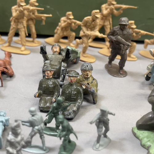 109 - A good number of plastic and metal model soldiers from Herald, Charbens and others, along with a LCT... 