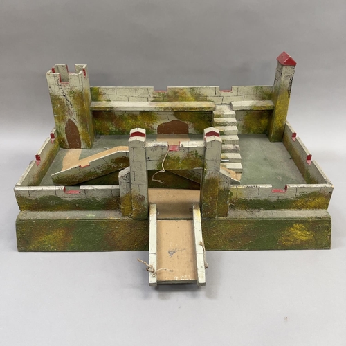 113 - A wooden toy castle with drawbridge and turrets, relief painted in greens and browns