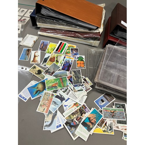 69 - Five cigarette card albums and a quantity of sleeves (empty), four trade card albums and a small num... 