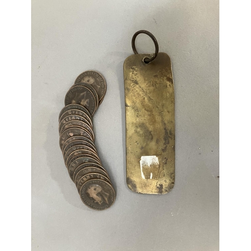 64 - An Edwardian Imperial Hotel brass room key together with twenty 1919 H pennies