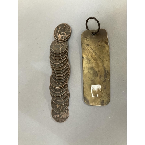 64 - An Edwardian Imperial Hotel brass room key together with twenty 1919 H pennies