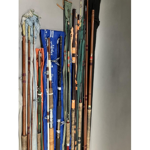 253 - A large carry case containing twenty-two fishing rods, various poles and a fishing chair