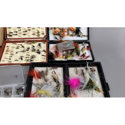 264 - Seven boxes of flies, various and a fishing fly brooch