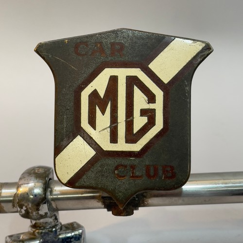 81B - A collection of four car mascots and owners club badges, including a Desmo terrier mascot, a MG Car ... 