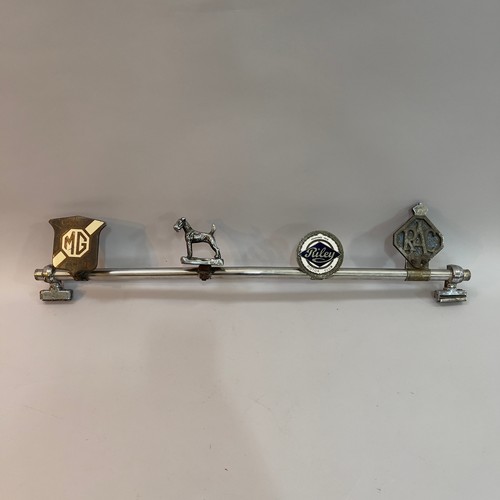 81B - A collection of four car mascots and owners club badges, including a Desmo terrier mascot, a MG Car ... 